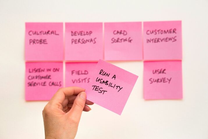 A person holding a sticky note