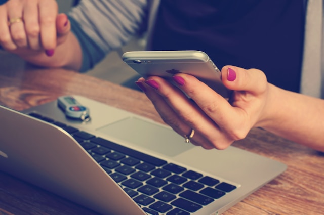 Alt Woman holding an iPhone-Mobile responsiveness
