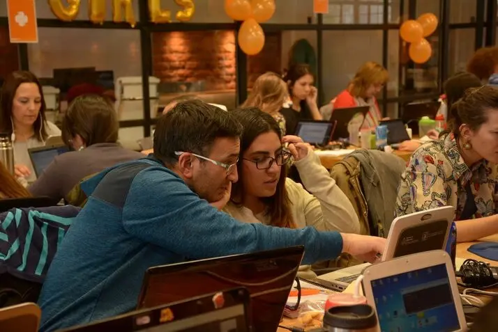a man showing a lady images on a screen