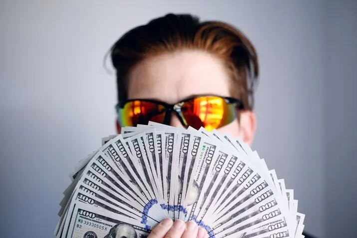 white guy holding money