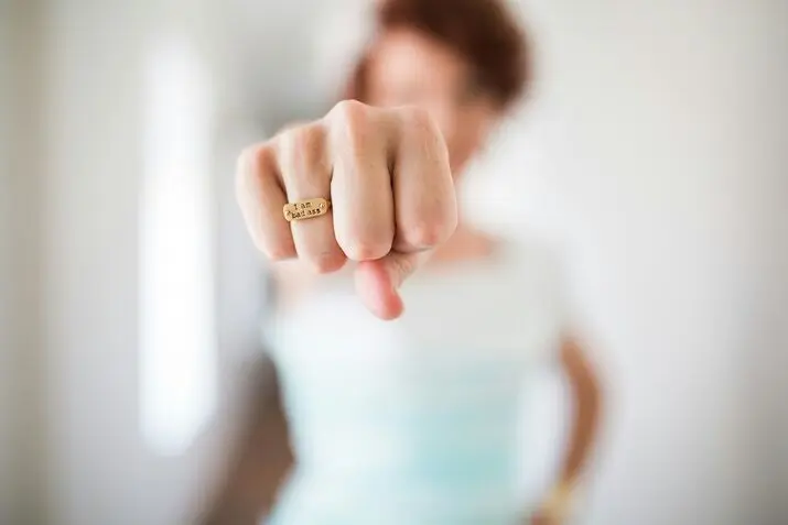 woman showing gold colored ring